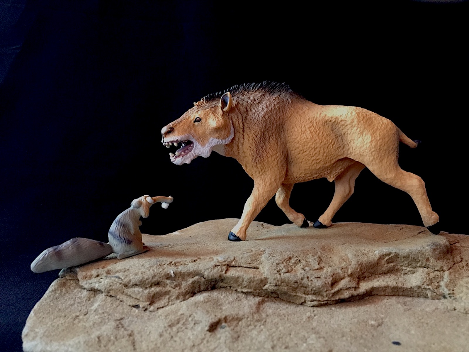 A carnivorous Sabre-Tooth Tiger attacking a young Deinotherium