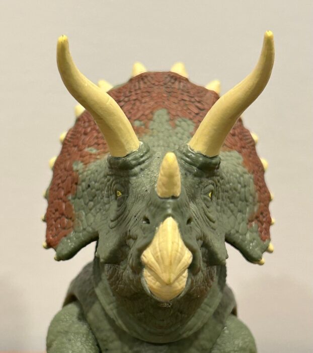 The face of a Triceratops toy action figure by Mattel
