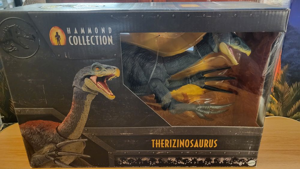 Therizinosaurus box front, has render of figure, and a plastic window to look at the figure